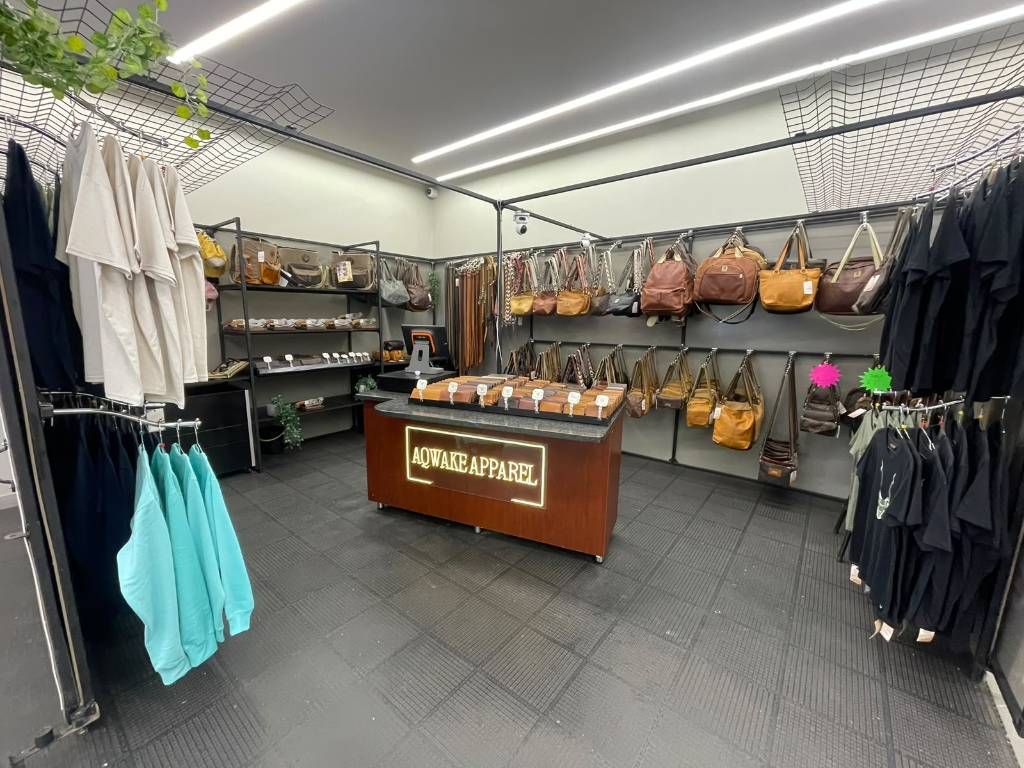 Inside Aqwake Apparel Kiosk showing Leather Handbags, Backpacks and Apparel
